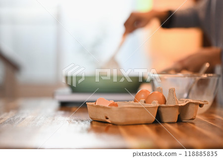Close up shot of organic eggs in a carton tray on a wooden kitchen counter Close up shot of organic eggs in a carton tray on a wooden kitchen counter 118885835