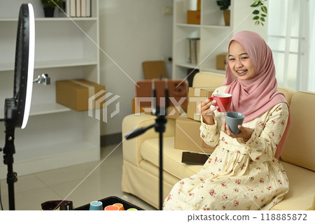 Smiling small business owner live streaming, presenting ceramics products to her audience. E-commerce concept 118885872