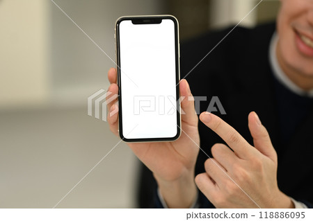 Close up image of man pointing finger at smartphone with blank screen Close up image of man pointing finger at smartphone with blank screen 118886095