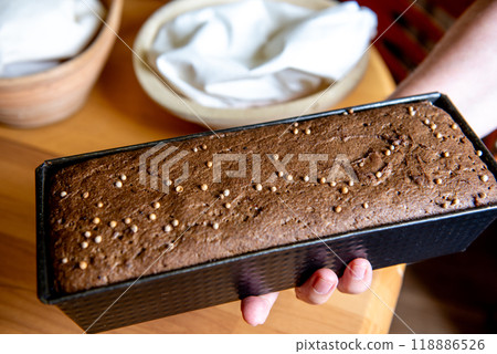 Loaf of bread with coriander seeds ready to be baked. Bread in the hands. Loaf of bread with coriander seeds ready to be baked. Bread in the hands. 118886526