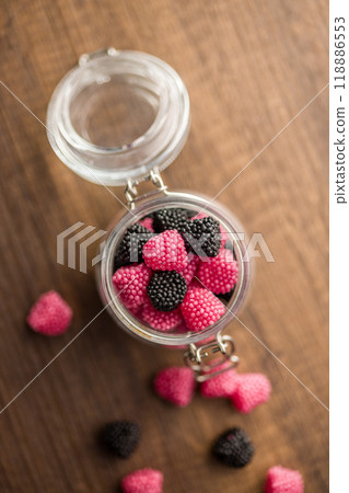 Sweet jelly candies in jar on wooden table. Top view. Sweet jelly candies in jar on wooden table. Top view. 118886553