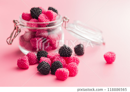 Sweet jelly candies in jar on pink background. Sweet jelly candies in jar on pink background. 118886565
