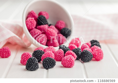 Sweet jelly candies in bowl on white table. Sweet jelly candies in bowl on white table. 118886569