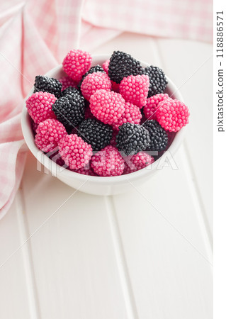Sweet jelly candies in bowl on white table. Sweet jelly candies in bowl on white table. 118886571