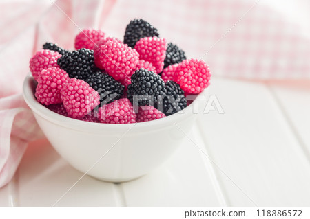 Sweet jelly candies in bowl on white table. 118886572