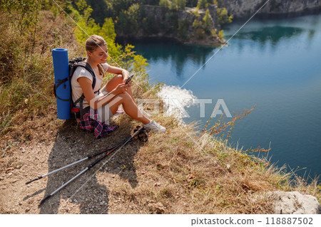 Embark on a Hiking Adventure by the Serene and Tranquil Lake Surrounded by Natures Beauty Embark on a Hiking Adventure by the Serene and Tranquil Lake Surrounded by Natures Beauty 118887502