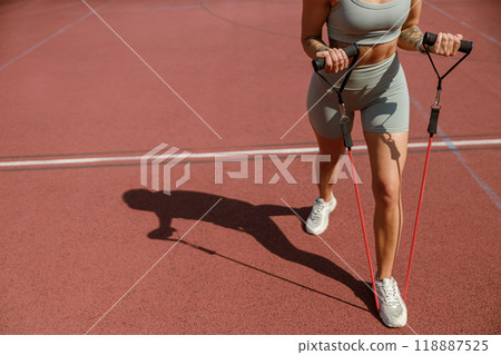 Engaging in a Full Active Workout Utilizing Resistance Bands on the Court for Fitness 118887525