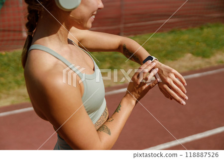 Fitness Tracker A Woman Diligently Monitoring Her Physical Activity in Stylish Athletic Gear 118887526