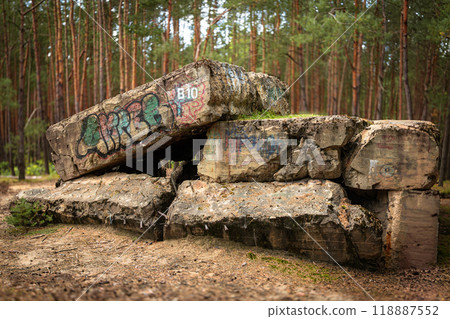 An old bunker from World War 2, forest and nature in the background. The bunker was blown up An old bunker from World War 2, forest and nature in the background. The bunker was blown up 118887552