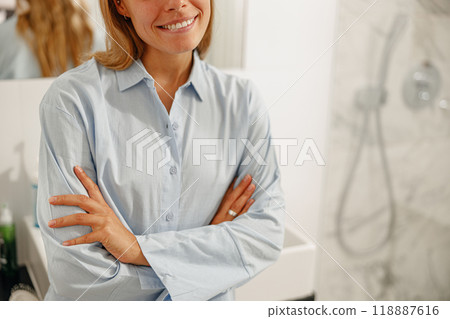 A Smiling Woman Posing Cheerfully in a Bright and Modern Bathroom Setting with Style 118887616