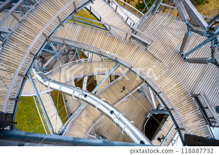 The Sky Walk Tower in Swieradow Zdroj offers breathtaking views of the Jizera Mountains. Visitors explore its intricate wooden pathways while enjoying nature from a unique perspective. The Sky Walk Tower in Swieradow Zdroj offers breathtaking views of the Jizera Mountains. Visitors explore its intricate wooden pathways while enjoying nature from a unique perspective. 118887732