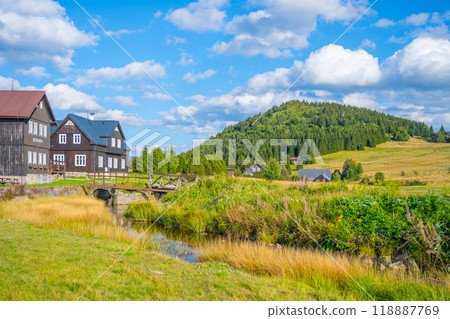 Jizerka village nestles at the foot of Bukovec Mountain, surrounded by lush forests and vibrant meadows 118887769