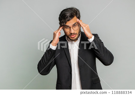 Indian man rubbing temples to cure headache problem, suffering from tension and migraine stress pain 118888334