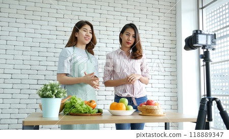 Asian influencer vlogger live review healthy eating lifestyle. Two Young woman friends blogger vlog happy lifestyle how to eating vegetables, fruit, vegan products. Two women talk social media vlog Asian influencer vlogger live review healthy eating lifestyle. Two Young woman friends blogger vlog happy lifestyle how to eating vegetables, fruit, vegan products. Two women talk social media vlog 118889347