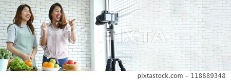 Banner Asian influencer vlogger live review healthy eating lifestyle. Banner Two woman friends blogger vlog happy lifestyle vegetables fruit salad. Two women talk social media vlog with copy space Banner Asian influencer vlogger live review healthy eating lifestyle. Banner Two woman friends blogger vlog happy lifestyle vegetables fruit salad. Two women talk social media vlog with copy space 118889348