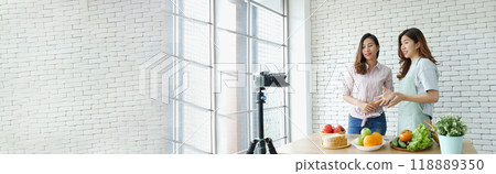 Banner Asian influencer vlogger live review healthy eating lifestyle. Banner Two woman friends blogger vlog happy lifestyle vegetables fruit salad. Two women talk social media vlog with copy space Banner Asian influencer vlogger live review healthy eating lifestyle. Banner Two woman friends blogger vlog happy lifestyle vegetables fruit salad. Two women talk social media vlog with copy space 118889350