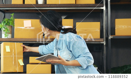 Online seller Close up hands Young asian woman typing laptop keyboard checking online order, check goods stock delivery package shipping postal. Asian woman startup small business at home office Online seller Close up hands Young asian woman typing laptop keyboard checking online order, check goods stock delivery package shipping postal. Asian woman startup small business at home office 118889352