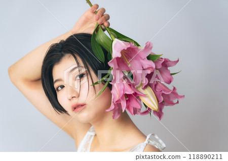 Beauty image of a woman holding flowers Skin care Cosmetics Beauty image of a woman holding flowers Skin care Cosmetics 118890211