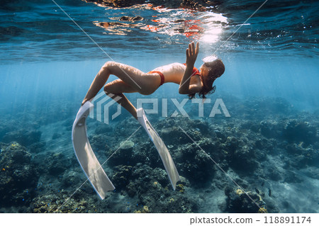 Woman with sexy body swimming in blue sea. Snorkeling with sexy girl 118891174