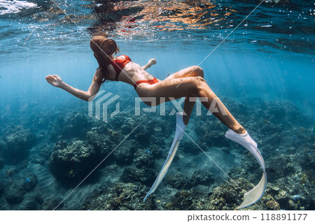 Woman with slim body in tropical blue sea. Snorkeling with sexy girl in Bali 118891177