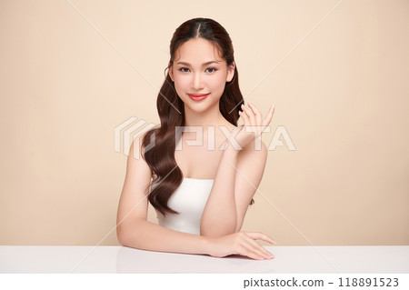 Beautiful young asian woman with clean fresh skin on beige background, Face care, Facial treatment, Cosmetology, beauty and spa, Asian women portrait. Beautiful young asian woman with clean fresh skin on beige background, Face care, Facial treatment, Cosmetology, beauty and spa, Asian women portrait. 118891523