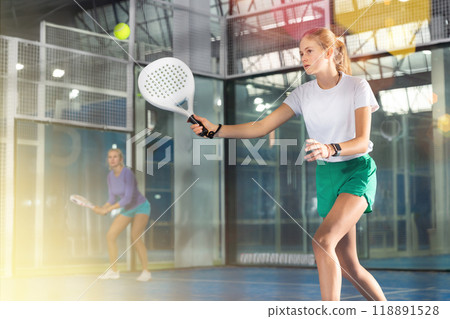 Girl tennis player playing padel tennis 118891528