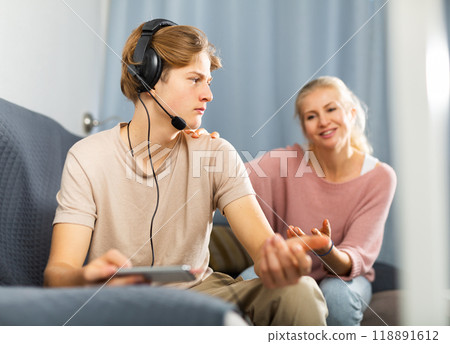 Mother asking for attention of her teenager son Mother asking for attention of her teenager son 118891612
