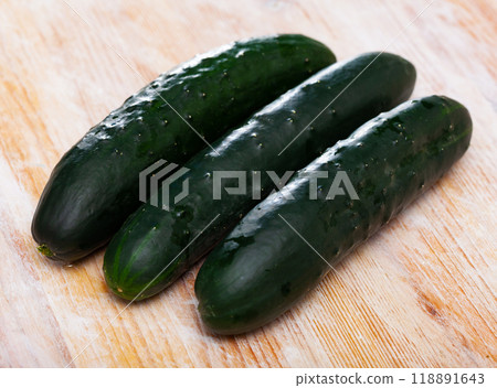 Cucumbers on wooden surface 118891643