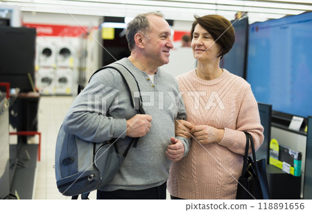 Mature man and woman shopping in appliance store Mature man and woman shopping in appliance store 118891656