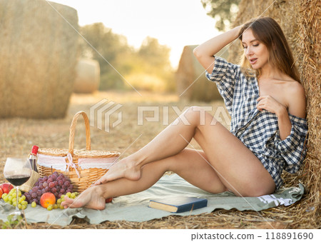 Young woman in shirt sitting during picnic 118891690