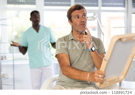 cosmetic physician confidently presents patient cosmetic physician confidently presents patient 118891724