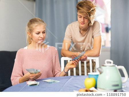 Mother giving some cash her teenager son 118891750