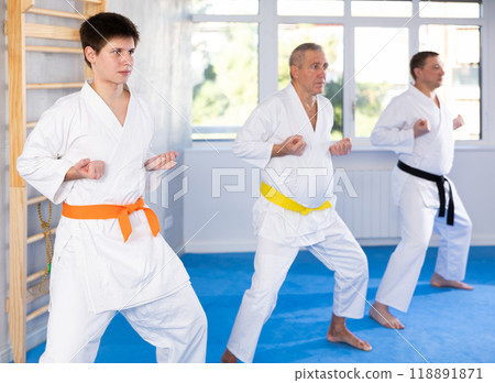 Young guy trains karate techniques in studio Young guy trains karate techniques in studio 118891871