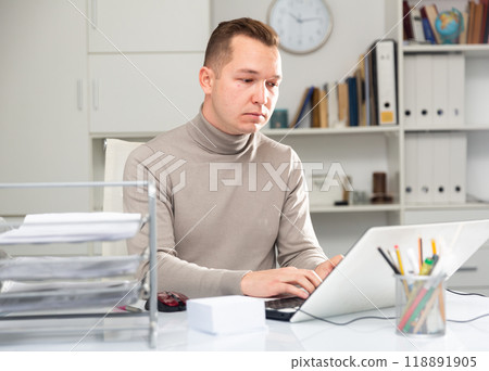 Male office manager using laptop computer 118891905