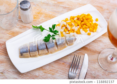 Delicious herring with corn, herbs and bread on long plate Delicious herring with corn, herbs and bread on long plate 118892137