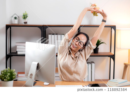 Portrait young asian businesswoman wearing glasses taking a break after overworked. 118892384