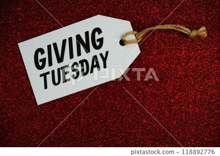 Giving Tuesday text message on paper tag with space for copy background Giving Tuesday text message on paper tag with space for copy background 118892776