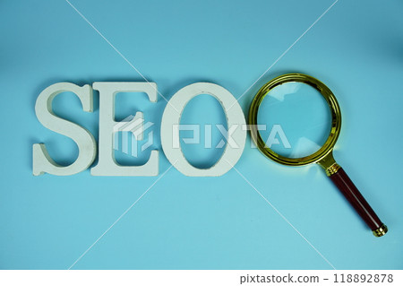 Seo words (Search Engine Optimization) letters with magnifying glass on blue background 118892878