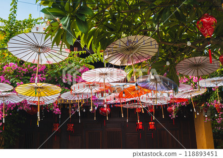 Colorful decorative Asian Japanese umbrellas decorate street in Hoi an in Asia 118893451
