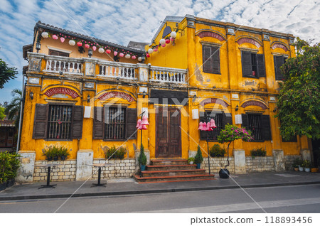 heritage facade of an ancient Asian yellow house in old town in Hoi An in Vietnam in Asia in summer 118893456