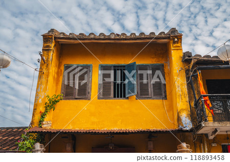 beautiful facade of an ancient Asian yellow house in old town in Hoi An in Vietnam in Asia 118893458