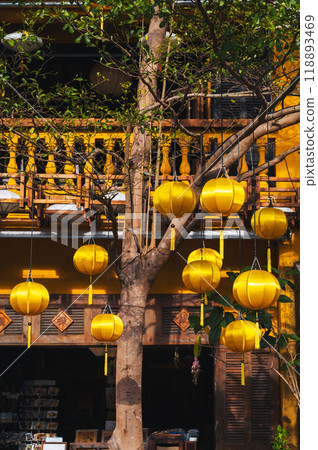 facade of an ancient Asian house decorated with yellow hanging Chinese lanterns for holiday in old town in Hoi An in Vietnam facade of an ancient Asian house decorated with yellow hanging Chinese lanterns for holiday in old town in Hoi An in Vietnam 118893469