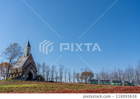 A church and a train seen beyond the flower fields of Hirugano Plateau Pastoral Village in autumn, Gujo City, Gifu Prefecture 118893638
