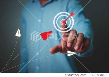 Businessman pointing finger at target icons while red paper airplane flying towards the target, Business target or goal success and winner concept, Goal setting, Strategic planning for business growth Businessman pointing finger at target icons while red paper airplane flying towards the target, Business target or goal success and winner concept, Goal setting, Strategic planning for business growth 118893862