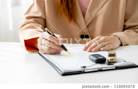 Customer hand signed the insurance contract documentation agreement for commercial auto car loan buying or vehicle rental service 118893878