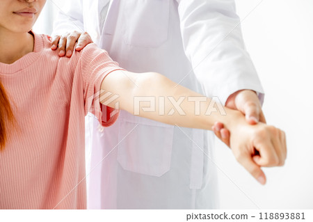 Female doctor hand rehab physical therapy by extending the pain shoulder of a patient. treatment with stretch exercises 118893881