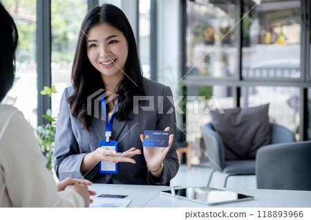 Employees present payment with mock up credit card payments to business customers. Ready to provide discounts and life insurance Employees present payment with mock up credit card payments to business customers. Ready to provide discounts and life insurance 118893966
