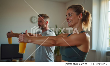 Young sporty woman with bottle of protein shake at home doing stretching exercise Young sporty woman with bottle of protein shake at home doing stretching exercise 118894047