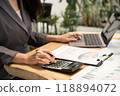 Businesswoman hand holding pen, analysis the graph with laptop at the home office for setting challenging business goals And planning to achieve the new target 118894072