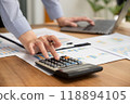 Businesswoman hand holding pen, analysis the graph with laptop at the home office for setting challenging business goals And planning to achieve the new target 118894105
